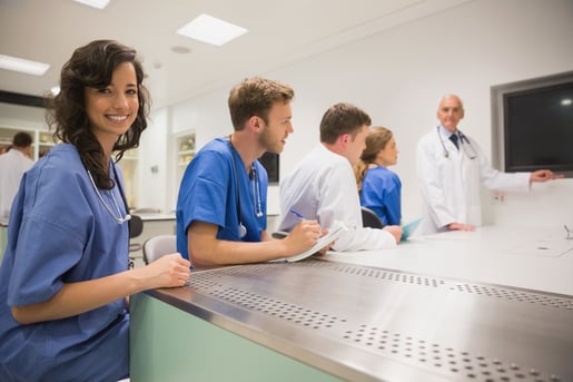 Medical student smiling at the camera during class at the university